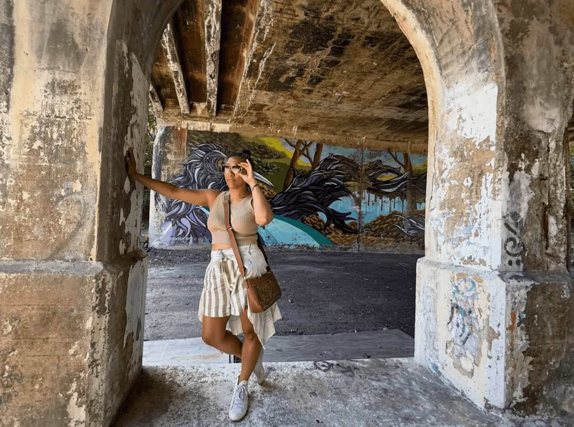 Autumn Hicks in warm light under a concrete archway